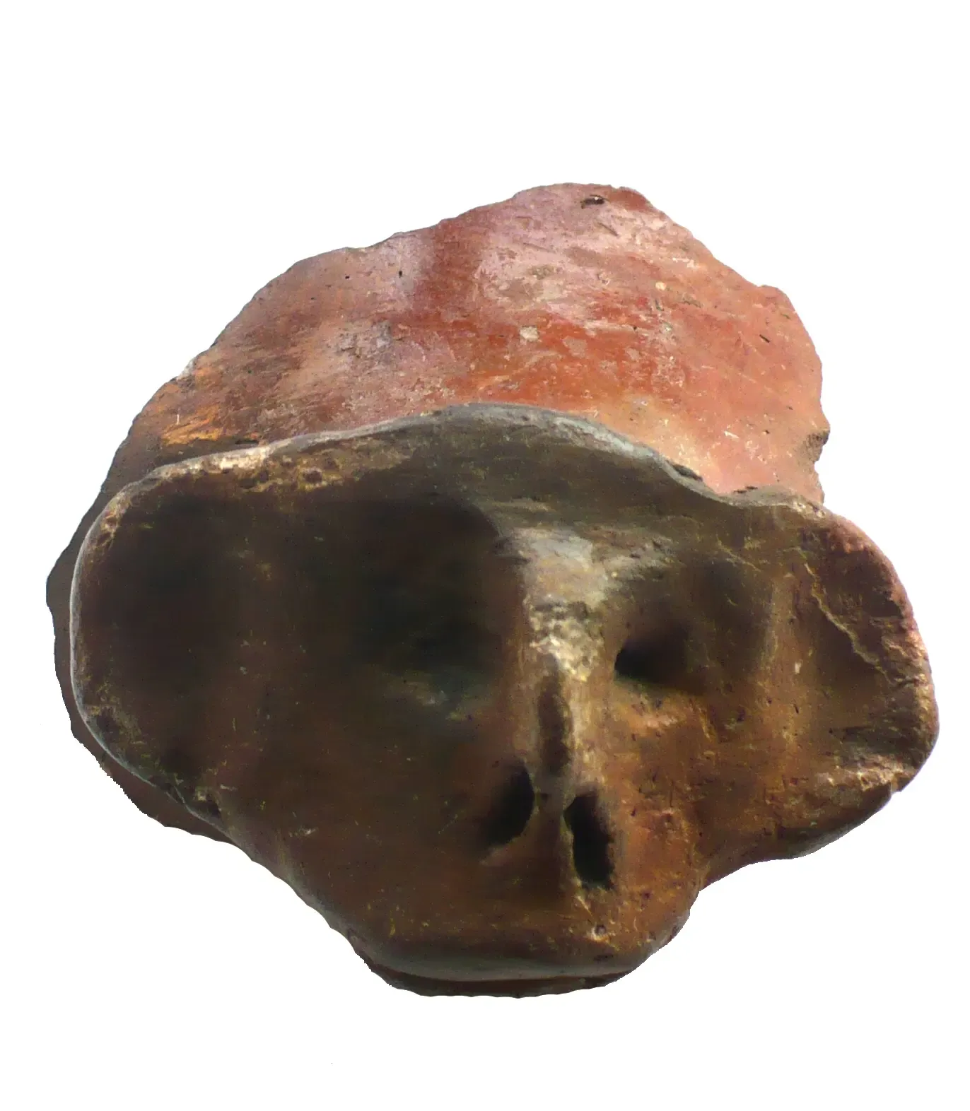 Fragment eines braungrauen bis orangefarbenen Keramikgefäßes mit abstrahiertem Gesicht. Eine Nase und große Ohren sind aus dem Ton herausgedrückt, Augen, schlitzförmige Nasenlöcher und ein breiter Mund sind eingeritzt.
